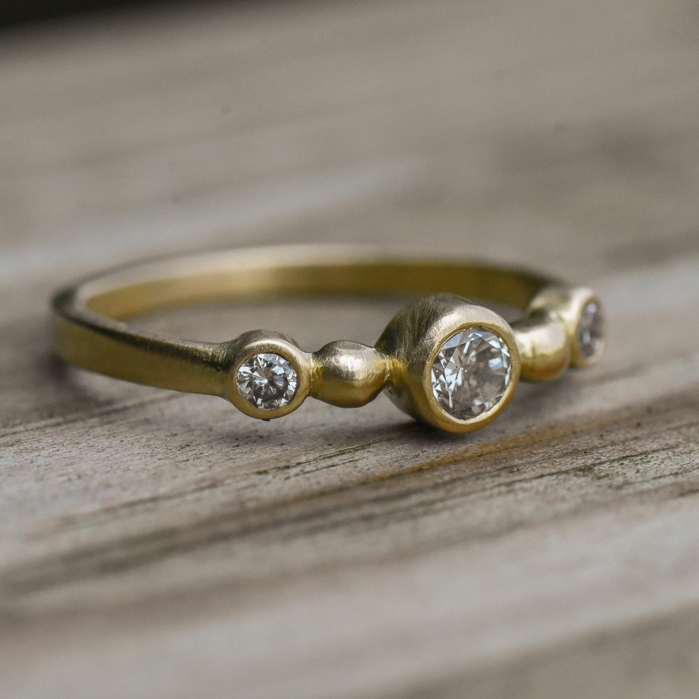 A closeup photo of a 14k gold diamond ring