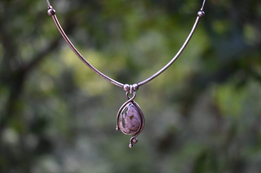 A photo of a necklace with an ocean jasper pendant