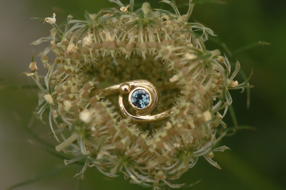 A photo of a 14k gold ring with a Montana blue sapphire